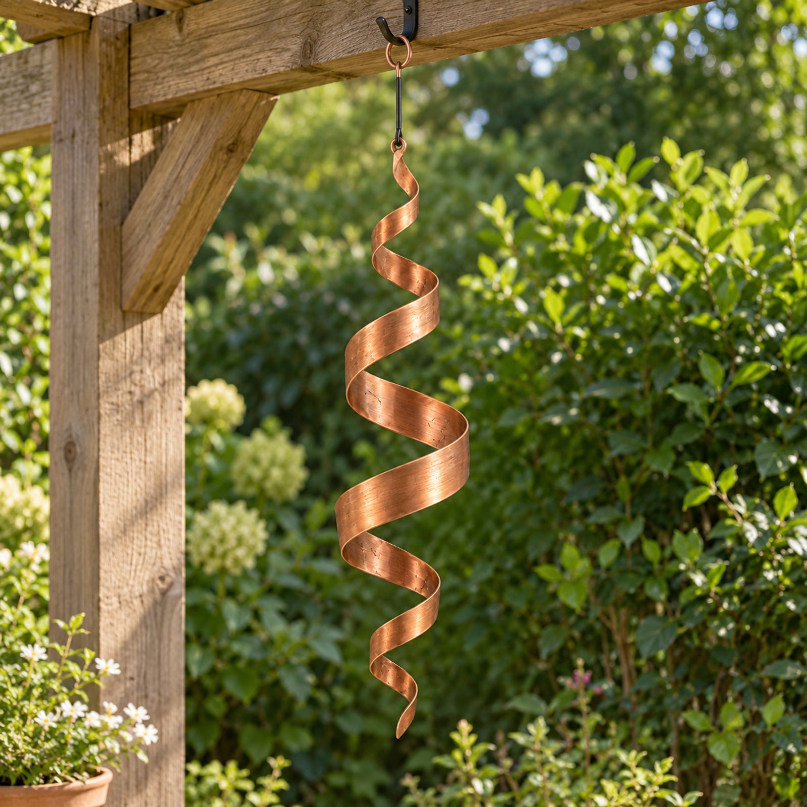 Copper-finish spiral hanging beneath a garden pergola